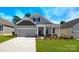 Charming one-story home featuring a covered front porch, two-car garage, and manicured lawn at 115 S Shayna Rd, Troutman, NC 28166