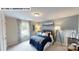 Comfortable bedroom with large windows, blue bedding, and neutral walls at 122 N Shayna Rd, Troutman, NC 28166