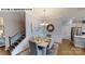 Elegant dining room featuring wainscoting, a modern chandelier, and easy access to kitchen at 122 N Shayna Rd, Troutman, NC 28166