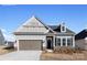 Charming single-story home showcasing a gray color scheme, a two-car garage, and a welcoming front entrance at 122 N Shayna Rd, Troutman, NC 28166