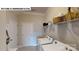 Functional laundry room with washer, dryer, shelves, decor, and neutral paint at 122 N Shayna Rd, Troutman, NC 28166