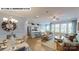 Open-concept living room with hardwood floors, a kitchen island, and ample natural light at 122 N Shayna Rd, Troutman, NC 28166