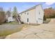 View of the backyard and driveway with a detached garage and a stairway to the back porch at 123 Scotch Irish Ln # 136, Troutman, NC 28166