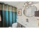 Modern bathroom featuring a vanity with a striking circular mirror and stylish vanity lighting at 123 Scotch Irish Ln # 136, Troutman, NC 28166
