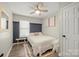 Cozy bedroom with stylish board and batten accent, bright window, and a ceiling fan at 123 Scotch Irish Ln # 136, Troutman, NC 28166