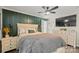 Comfortable main bedroom with a board and batten accent wall, neutral-toned linens, and ample natural light at 123 Scotch Irish Ln # 136, Troutman, NC 28166