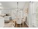 Charming dining area with stylish chandelier, decorative art, and a large window at 123 Scotch Irish Ln # 136, Troutman, NC 28166