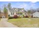 Charming two-story home with a welcoming front porch and well-maintained landscaping at 123 Scotch Irish Ln # 136, Troutman, NC 28166