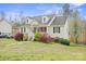 Quaint home exterior with a well-kept lawn and vibrant shrubs and lush yard at 123 Scotch Irish Ln # 136, Troutman, NC 28166