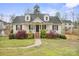 Inviting home with a covered porch, brick foundation and flourishing lawn and landscaping at 123 Scotch Irish Ln # 136, Troutman, NC 28166