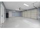 Spacious garage with a rolling door and an extra door. Plenty of room for vehicles at 123 Scotch Irish Ln # 136, Troutman, NC 28166
