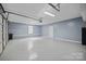 A spacious two-car garage is freshly painted with a clean and organized feel at 123 Scotch Irish Ln # 136, Troutman, NC 28166