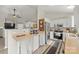 Well-lit kitchen featuring white cabinets, stainless steel appliances, and an eat-in counter with bar seating at 123 Scotch Irish Ln # 136, Troutman, NC 28166