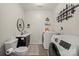Well-lit laundry room featuring a washer and dryer, sink, toilet, and modern decorations at 123 Scotch Irish Ln # 136, Troutman, NC 28166
