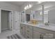 Bright bathroom featuring double vanity with white countertop, framed mirrors, and stylish fixtures at 12709 Messenger Row, Huntersville, NC 28078