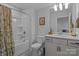 Clean bathroom featuring a shower-tub, granite vanity, and ample lighting at 12709 Messenger Row, Huntersville, NC 28078