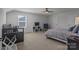 Bright bedroom features a large window and neutral carpeting at 12709 Messenger Row, Huntersville, NC 28078