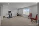 Versatile bonus room with exercise equipment and comfortable seating area at 12709 Messenger Row, Huntersville, NC 28078