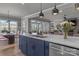 Kitchen island with stainless steel sink and faucet, with an open view to the dining and living rooms at 12709 Messenger Row, Huntersville, NC 28078