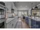 Spacious kitchen featuring stainless steel appliances, white and navy cabinets, and a large island at 12709 Messenger Row, Huntersville, NC 28078