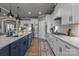 A kitchen offers stainless steel appliances, two-tone cabinets, granite countertops, and modern lighting at 12709 Messenger Row, Huntersville, NC 28078