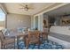 Covered patio boasts stylish furniture, ceiling fan, and seamless indoor-outdoor living with a sliding door entrance at 12709 Messenger Row, Huntersville, NC 28078