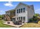 A multi-level backyard with a patio, grilling area, outdoor dining set, and lush landscaping. Perfect for entertaining outdoors at 1274 Fishing Creek Rd # 134, Clover, SC 29710
