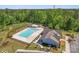 Aerial view of a community pool featuring a six-lane pool and a clubhouse nestled among lush trees at 1274 Fishing Creek Rd # 134, Clover, SC 29710