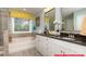 Bathroom with tile shower, soaking tub, double vanity with granite counters and white cabinets at 130 Fordingbridge Ln, Mooresville, NC 28115