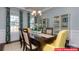 Bright dining room featuring a large wood table, modern chandelier, and elegant decor at 130 Fordingbridge Ln, Mooresville, NC 28115
