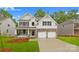 Charming two-story home boasts stone accents, a covered porch, and a convenient two-car garage at 130 Fordingbridge Ln, Mooresville, NC 28115