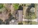 Aerial view showcasing the property's roof, driveway, mature trees, and landscaping at 1315 Vickie Ln, Matthews, NC 28104