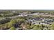 An aerial view of modern townhomes nestled amongst green trees near commercial establishments and a highway at 1315 Vickie Ln, Matthews, NC 28104