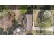 An overhead shot of a home with a brown roof, surrounded by trees, showcasing the lot and landscaping at 1315 Vickie Ln, Matthews, NC 28104