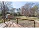 Deck overlooking the expansive backyard featuring a storage shed and mature trees at 1315 Vickie Ln, Matthews, NC 28104