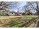 View of the exterior of the home with a deck overlooking a spacious backyard with storage shed at 1315 Vickie Ln, Matthews, NC 28104