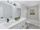 Bright, remodeled bathroom with double vanity, shower with tub and sleek modern lighting at 1315 Vickie Ln, Matthews, NC 28104