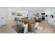 Bright dining area with modern table set, hardwood floors and connected to an open-concept living room and kitchen at 1315 Vickie Ln, Matthews, NC 28104