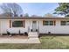 Charming single-story home with a white brick exterior, updated windows, and a well-manicured lawn at 1315 Vickie Ln, Matthews, NC 28104