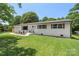 Exterior shot of a charming one-story home with a well-maintained lawn and eye-catching curb appeal and a new garage at 1315 Vickie Ln, Matthews, NC 28104
