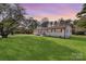 Charming white brick home with a well-manicured lawn and lovely trees in a quiet neighborhood at 1315 Vickie Ln, Matthews, NC 28104