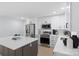 Well-lit kitchen with stainless steel appliances, white cabinets, and a large island with barstool seating at 1315 Vickie Ln, Matthews, NC 28104