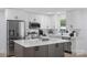 Modern kitchen featuring white cabinets, stainless steel appliances, and a large island with a white countertop at 1315 Vickie Ln, Matthews, NC 28104