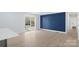 Bright and spacious living room with hardwood floors, adjacent to a sliding glass door and paneled accent wall at 1315 Vickie Ln, Matthews, NC 28104