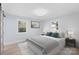 Well-lit bedroom with two windows and a comfortable bed adorned with decorative pillows and a gray blanket at 1315 Vickie Ln, Matthews, NC 28104
