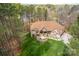An eye-level aerial view of this home with lush lawns, mature landscaping and surrounding woods at 135 Frostcliff Ln, Mooresville, NC 28117