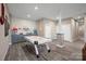 Basement featuring an air hockey table, kitchenette, and neutral decor at 135 Frostcliff Ln, Mooresville, NC 28117