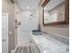 Elegant bathroom with a walk-in shower, marble countertop, and modern fixtures at 135 Frostcliff Ln, Mooresville, NC 28117