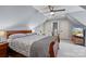 Bedroom with a ceiling fan, sloped ceilings and multiple doors at 135 Frostcliff Ln, Mooresville, NC 28117