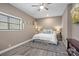 Cozy bedroom featuring a ceiling fan, natural light, and a comfortable rug at 135 Frostcliff Ln, Mooresville, NC 28117